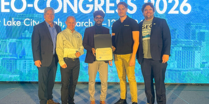 2026 DIGGS Hackathon winner accepts his award.