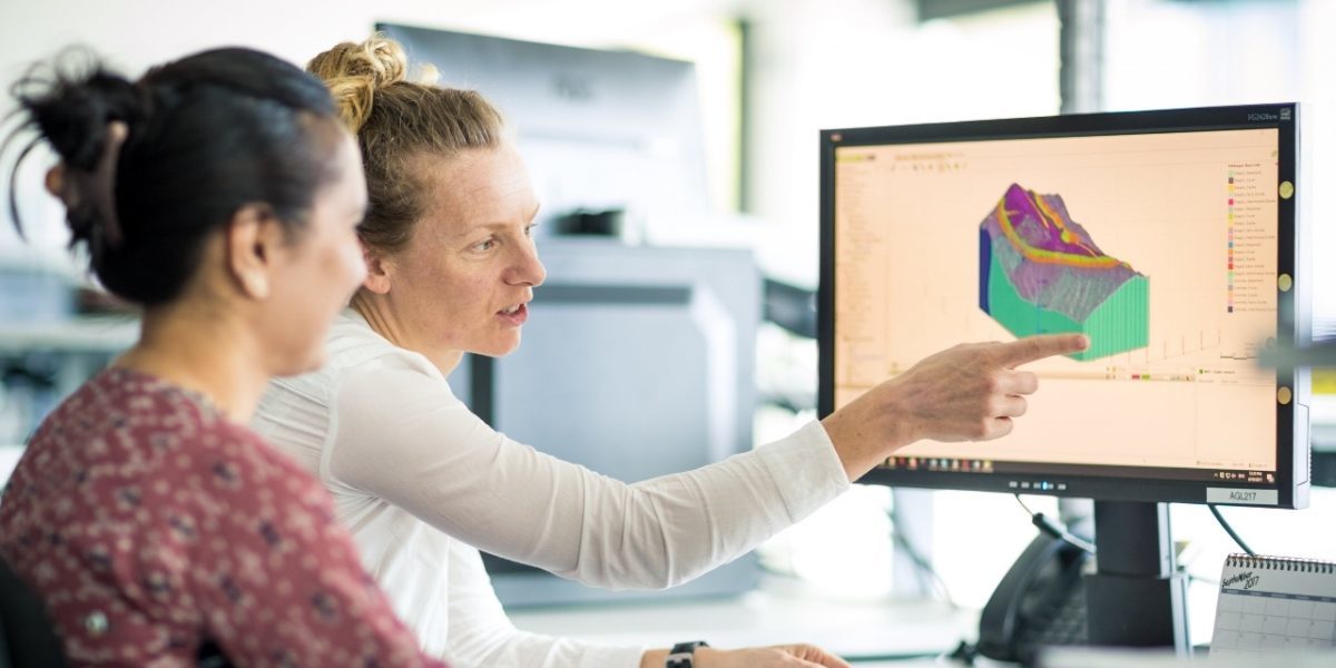 Two people looking at a computer screen