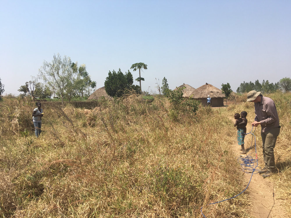 Running a resistivity survey through fields and cassava shrubs