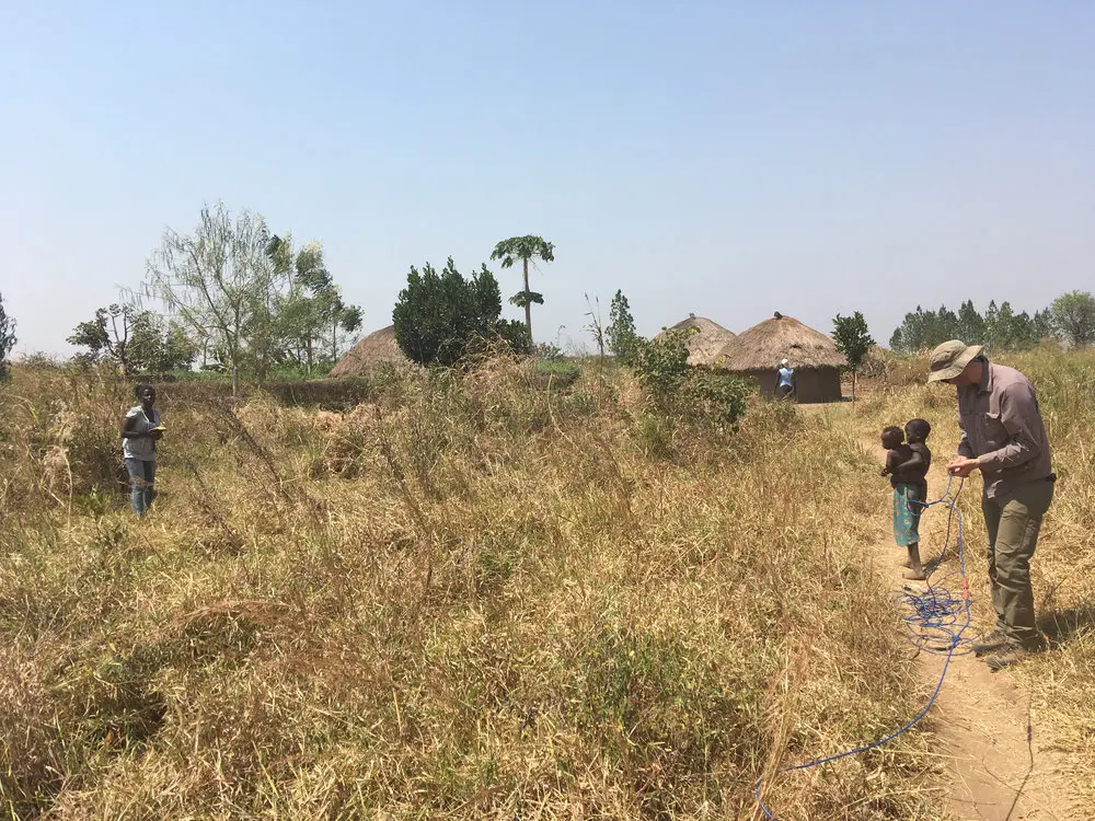  Running a resistivity survey through fields and cassava shrubs 