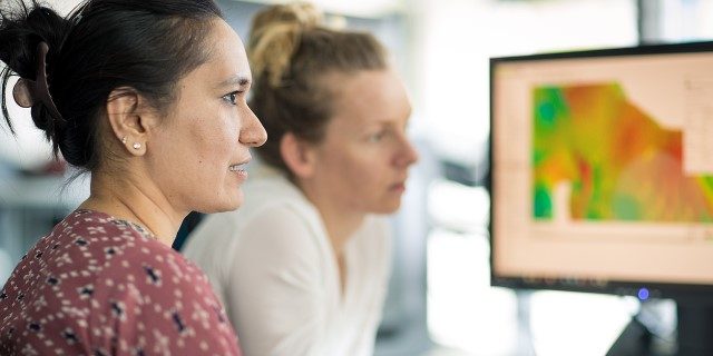 two people looking at computer screen