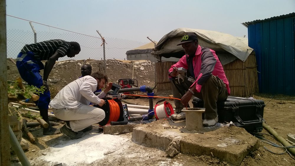  Geraint (middle) setting up a borehole camera survey 