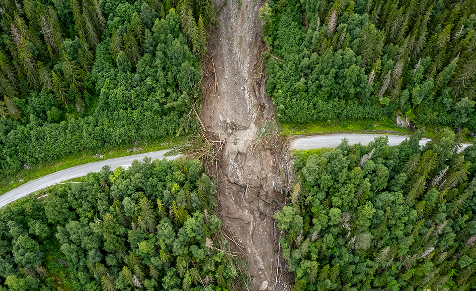 Aerial photo of landslide across forested road