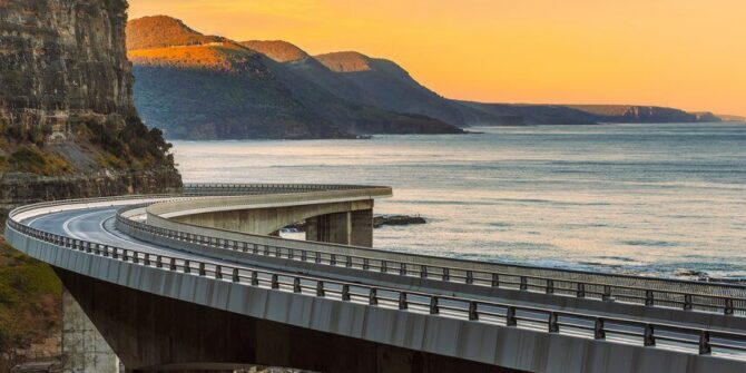 Sunset over the Sea cliff bridge along Australian Pacific ocean coast near Sydney, Australia. Shutterstock_738714217