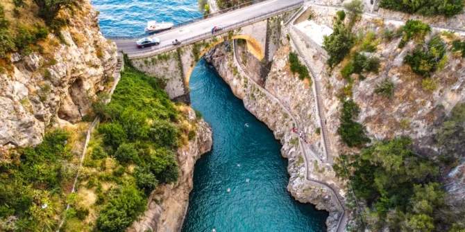 Aerial view of the beautiful stone bridge Furore Fjord, and a small town along the Amalfi Coast, Salerno, Campania, Italy.