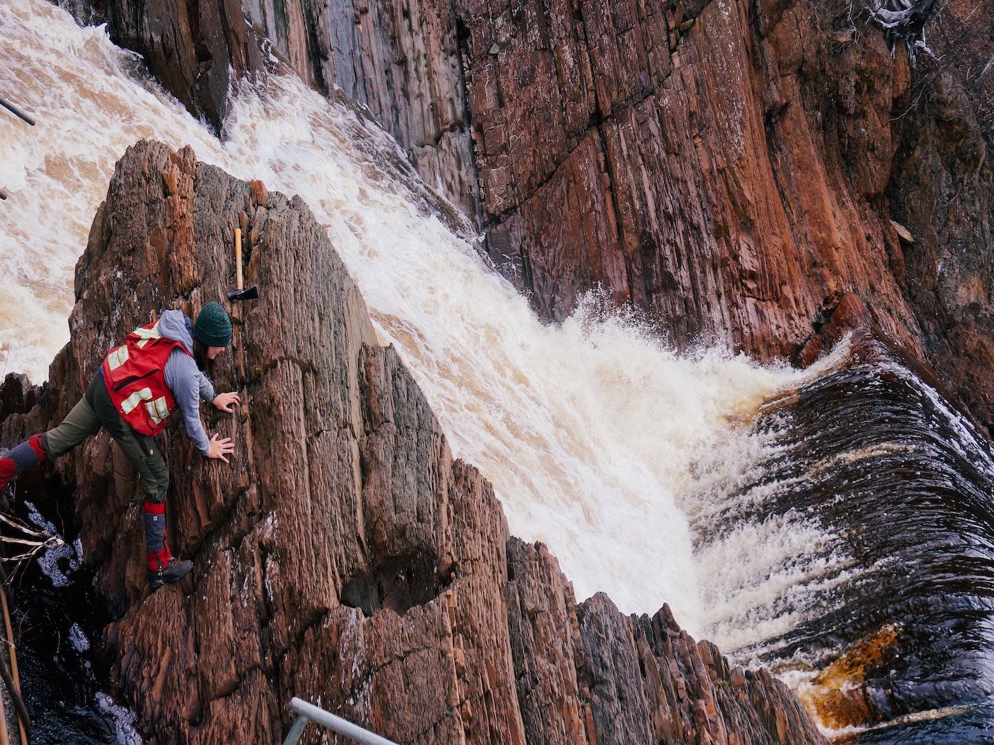 Deciphering an outcrop next to a sideways waterfall. Hands-on field mapping forces you to look at the situation from multiple angles.