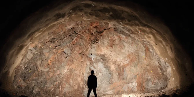 Mine, tunnel front, silhouette of a standing worker. GettyImages-166029447