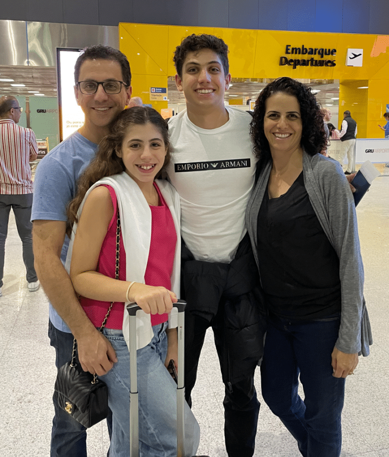 A photograph of Daniela Ximenes, a member of the Seequent LAM team, with her family at an airport