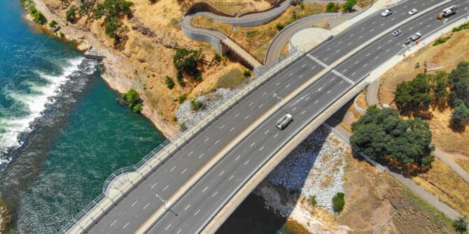 A photo of a bridge over water and land