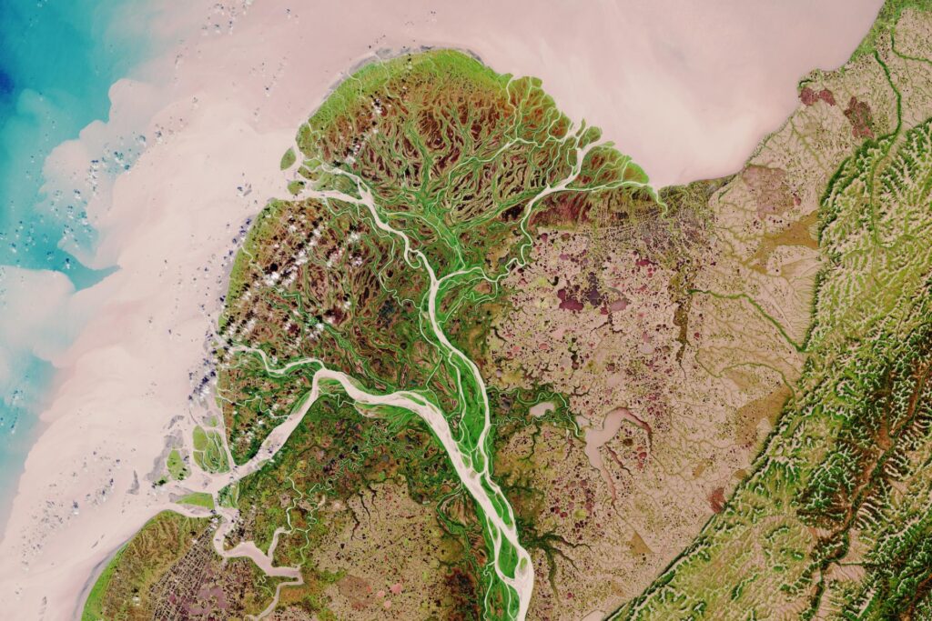 An aerial image view of a river delta where a river system meets the coastline.