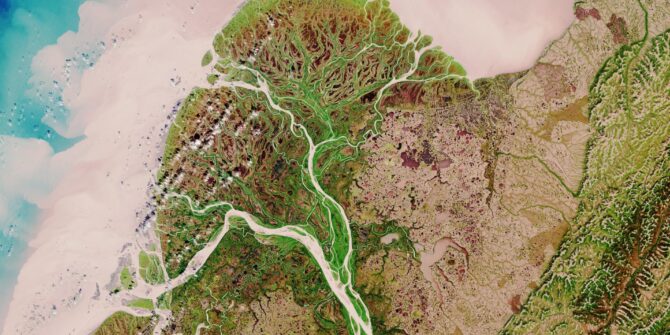 An aerial image view of a river delta where a river system meets the coastline.