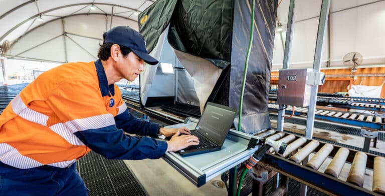 A photo showing an exploration geologist using Seequent's high-quality core image capture and storage technology Imago.