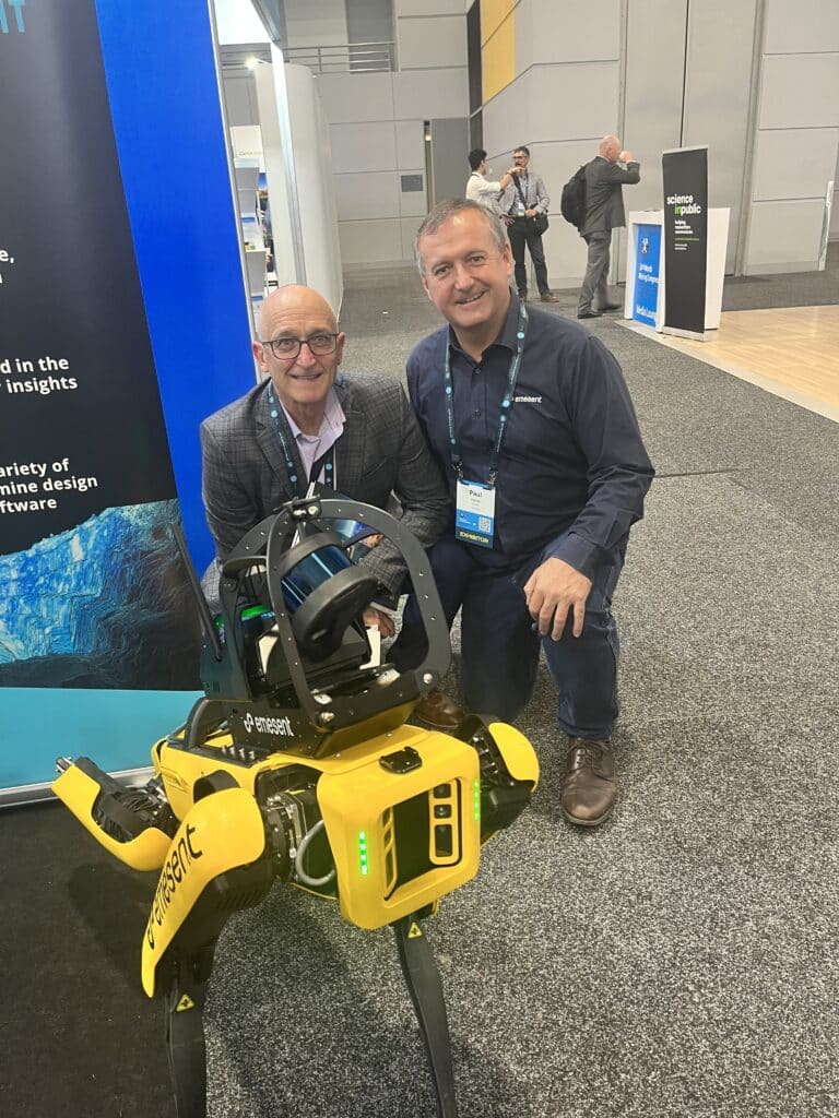 A photo of Seequent's Pieter Neethling with Paul Fenner checking out AI-driven LiDAR robot Spot at the Mining Congress 2023