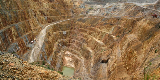 View into the base of the pit of a large open cast gold mine.
