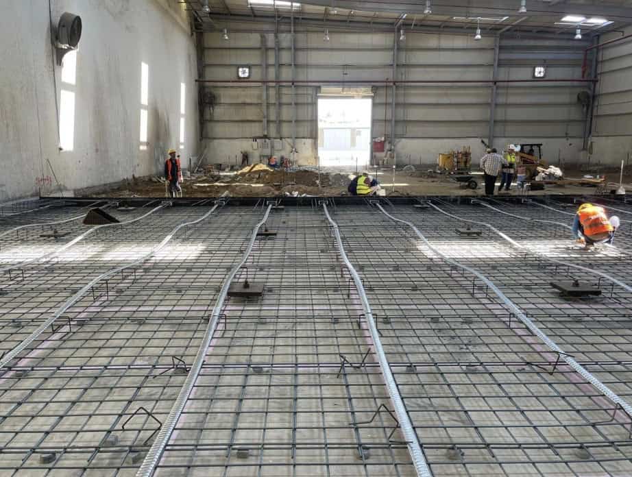 Preparing to pour the concrete slab around the steel cables that would then be tensioned. The square plates each sit atop a micropile. Source: Supplied