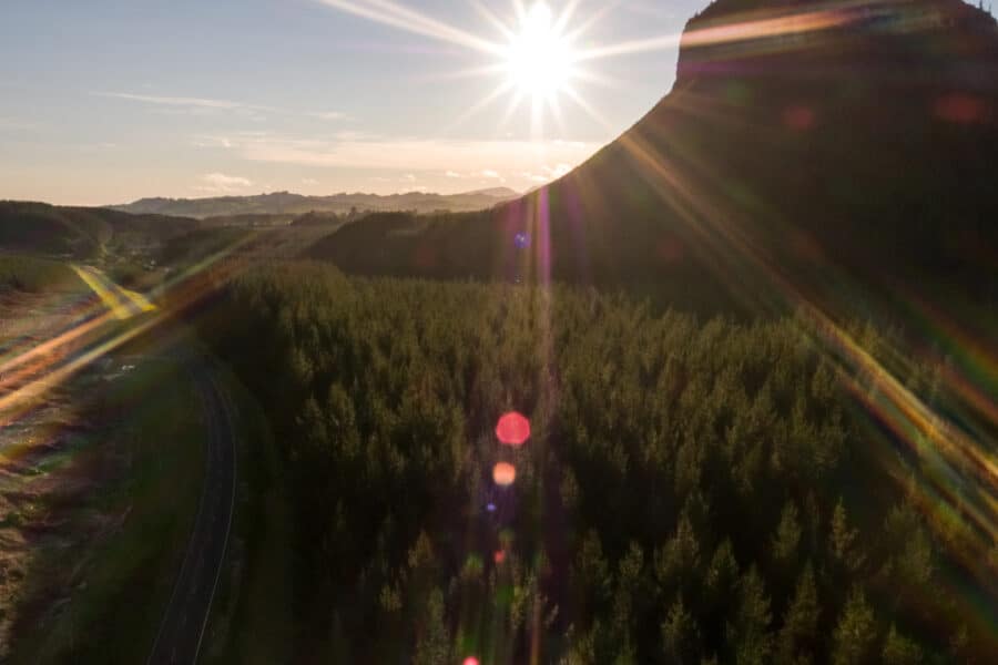 A photo of a sunset over a rocky, forested landscape, Seequent.