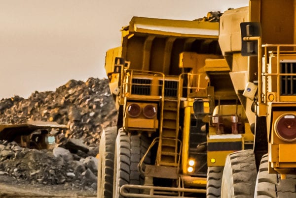 Big yellow trucks carrying rock