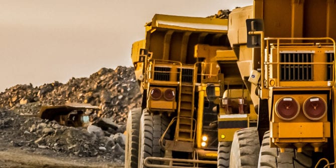 Big yellow trucks carrying rock