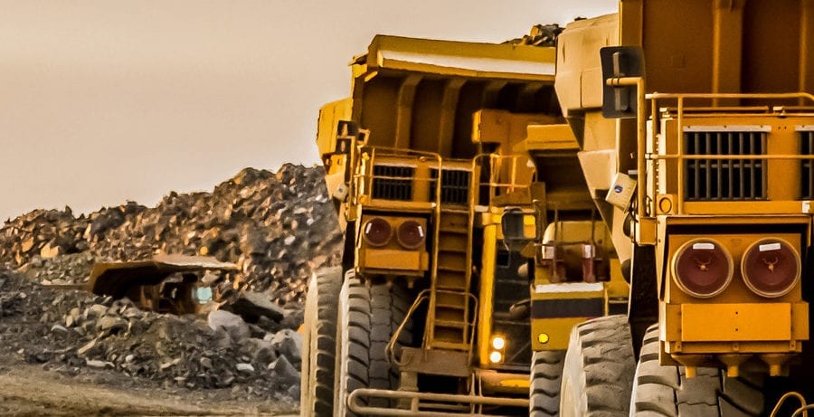Big yellow trucks carrying rock