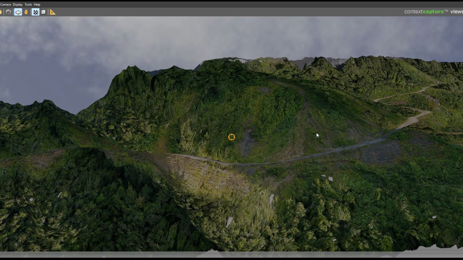 A 3D terrain model showing a steep, forested mountainside with a narrow dirt road cutting across it. The interface of a mapping or modelling software is visible along the top of the screen. (Source: PT Hutama Karya).