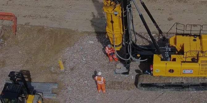 Drill with two men standing closeby