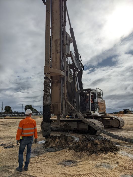 A photo showing construction worker and machinery used to make site ground improvement.