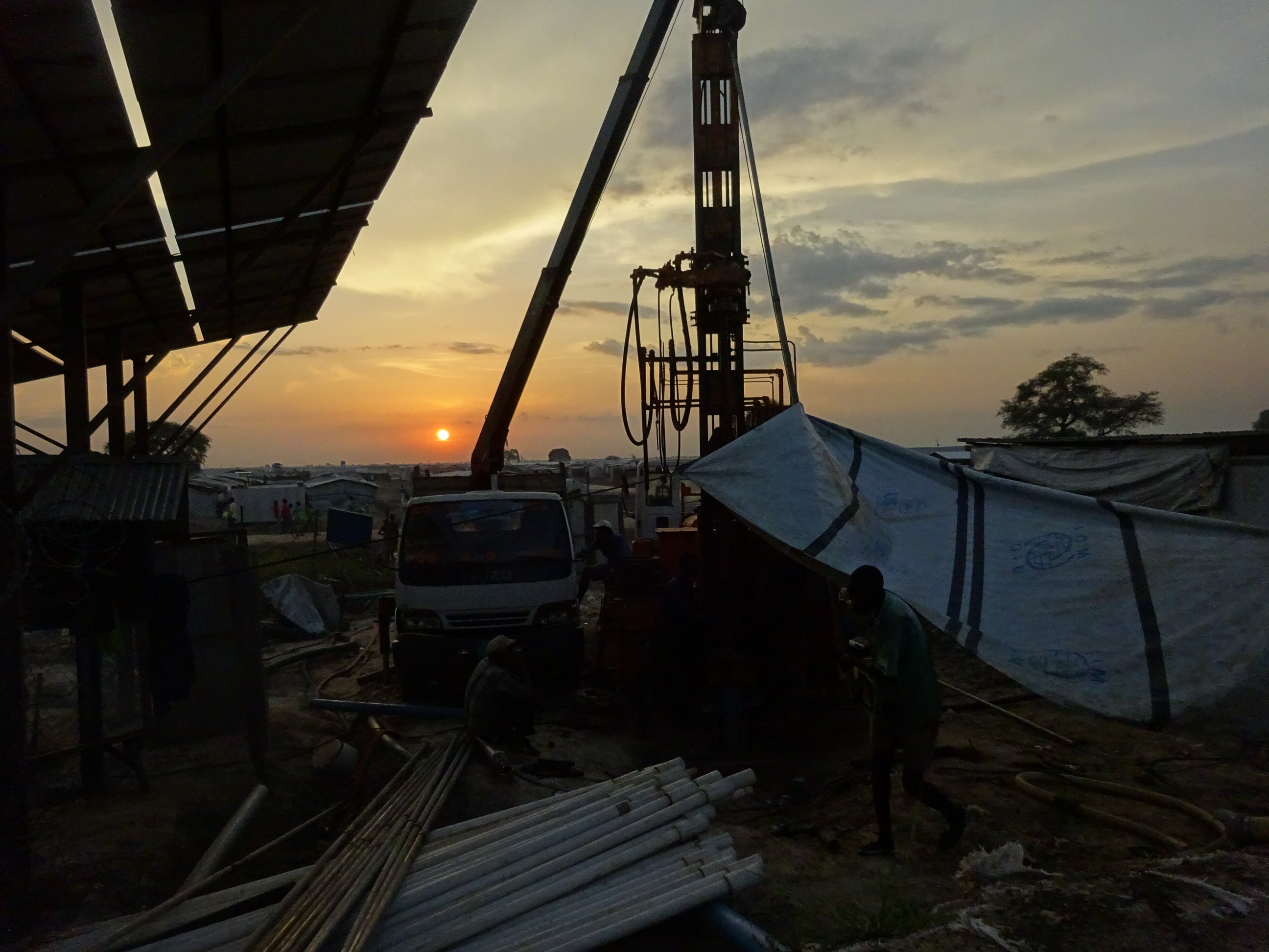 drilling boreholes at sunset