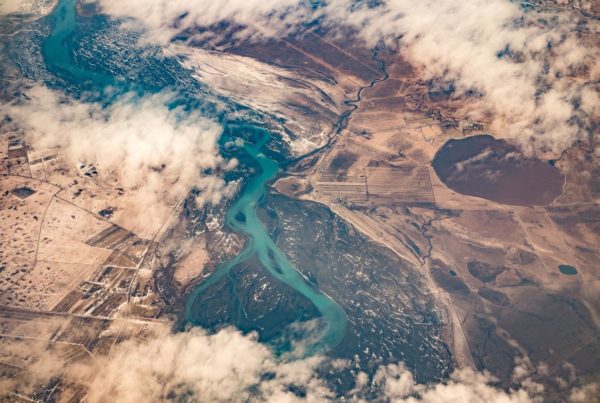 a photo from up high looking down over a river, with clouds obscuring some of the view