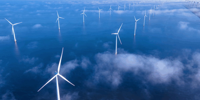 a photo of a wind farm in the ocean