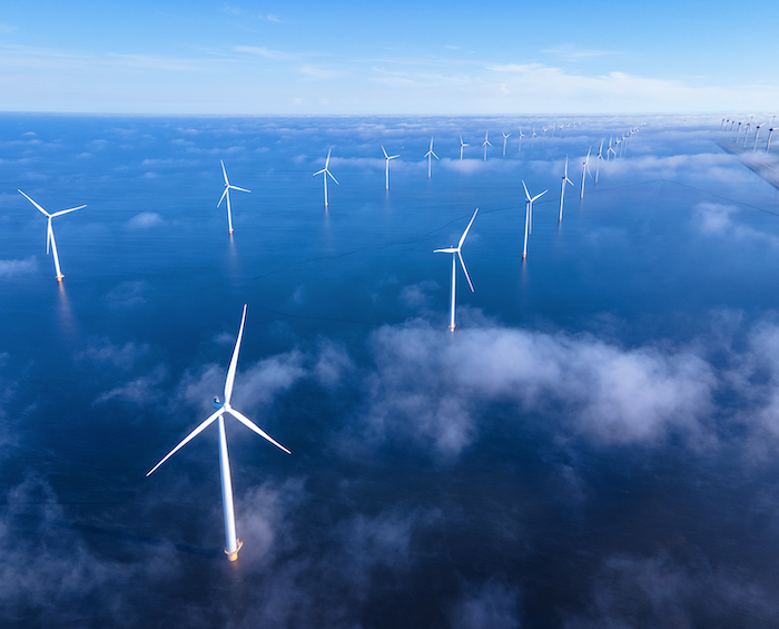 a photo of a wind farm in the ocean
