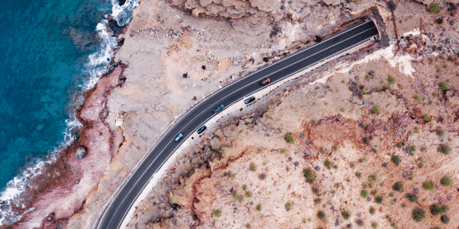 arial photo of a road bridge next to the ocean