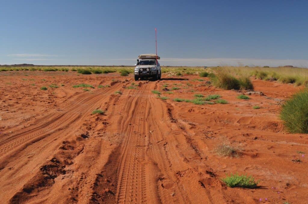 photo of a 4wd on a desert track