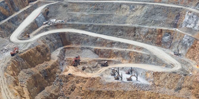 A photo from above a mine, with machines drilling boreholes.