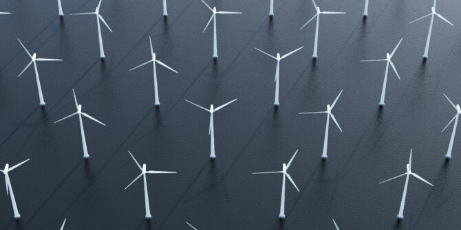 Aerial view of modern wind turbines plant in the sea.