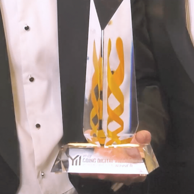 A photograph of a man holding a Bentley Going Digital in Infrastructure award